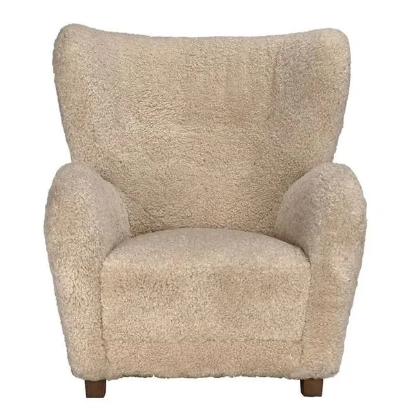 Front-facing Pola Chair highlighting wide backrest and woolly texture