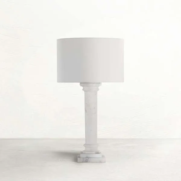 Tall table lamp with a white marble column base and a simple cylindrical white fabric shade