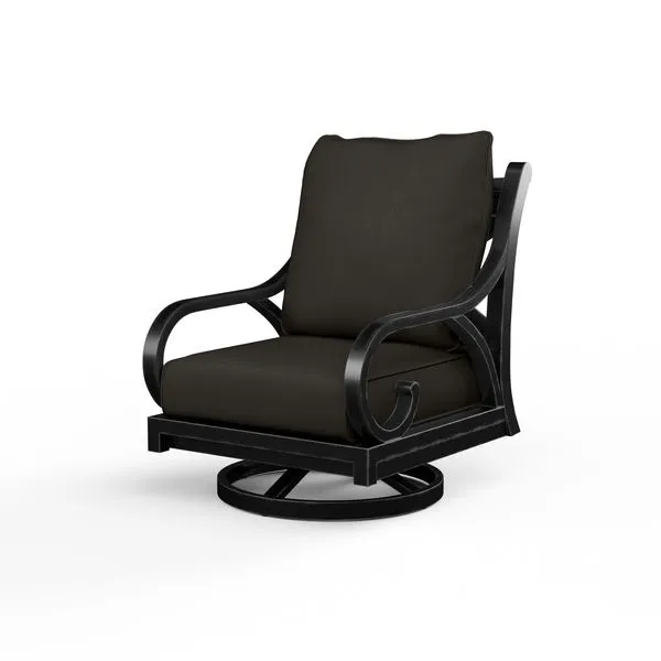 Outdoor swivel rocker chair with curled arms, cross back detail, black cushions, and round base in espresso finish