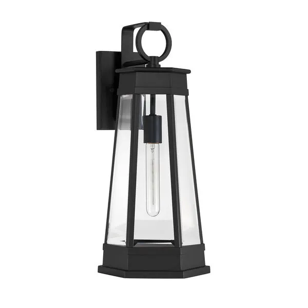 Close-up side view of matte black outdoor lantern revealing slim tubular bulb and geometric detailing