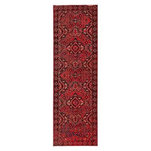Long rectangular indoor-outdoor rug with a vivid red and black Turkish-inspired medallion pattern
