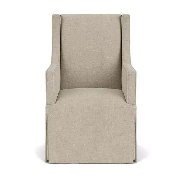 Front view of chair showing symmetrical arms and streamlined upholstery with tailored skirt