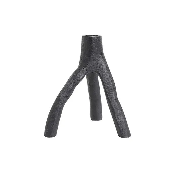Black cast iron candle holder with three uneven, branch-like legs and a textured surface