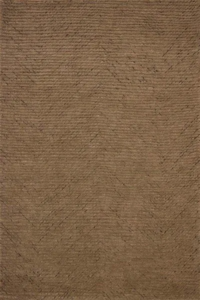 Hand-tufted wool area rug in rich earth tones with a ribbed pile and subtle chevron pattern