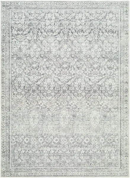 Charcoal machine woven rug with intricate vintage floral motifs in subdued gray tones and a decorative border