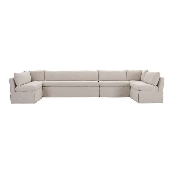 U-shaped slipcover dining banquette in neutral beige with tilted back, pillow cushions, and inverted pleat skirt