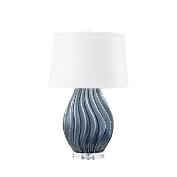 Ceramic table lamp with wavy blue glaze body on clear acrylic base, topped with white drum shade