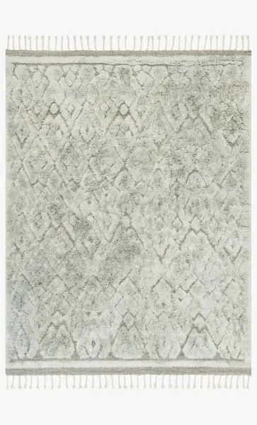 Soft grey shag rug with subtle diamond motifs and fringed edges in a neutral Scandinavian style
