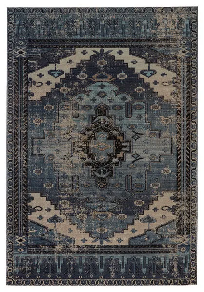 Indoor-outdoor rug with a bold tribal medallion pattern in blue and gray tones, inspired by antique Turkish rugs.