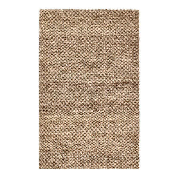 Rectangular handwoven jute rug in neutral beige tones with a chunky braided texture