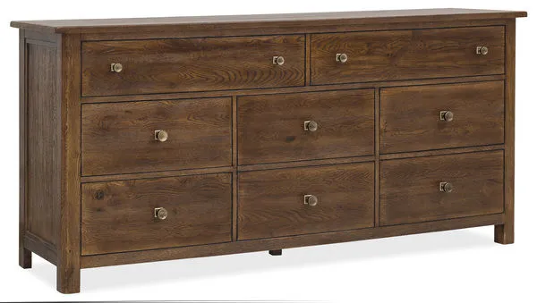 Eight-drawer dresser in worn saddle finish with brass knobs and visible wood grain texture