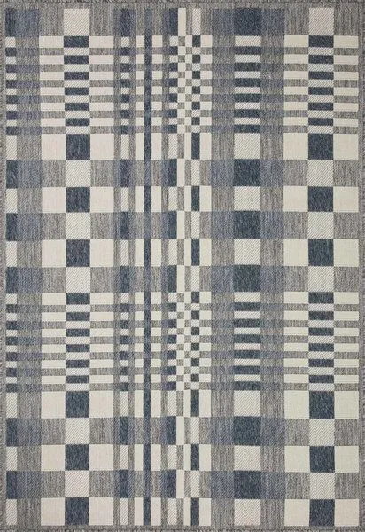 Rainier Ivory / Denim indoor/outdoor rug with a checkered pattern of varying square sizes in ivory, denim blue, and gray hues