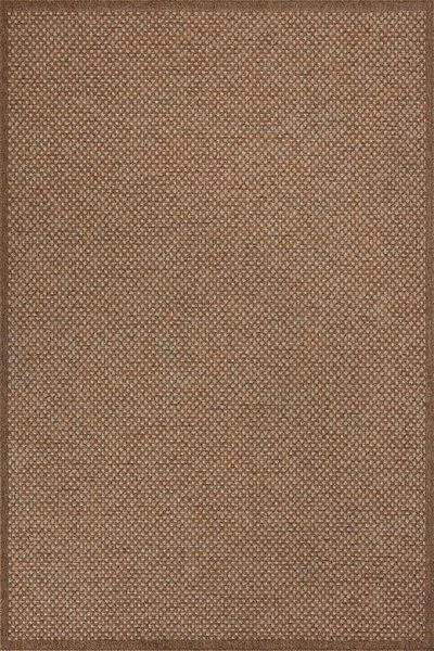 Rectangular indoor/outdoor rug in warm rust tones with small woven checkered pattern and clean edge