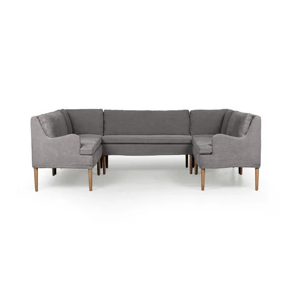 U-shaped dining banquette with high back, gently curved arms, gray flax linen upholstery, and slim tapered wood legs