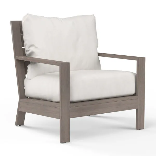 Laguna Club Chair with driftwood-finish aluminum frame and thick white seat and back cushions