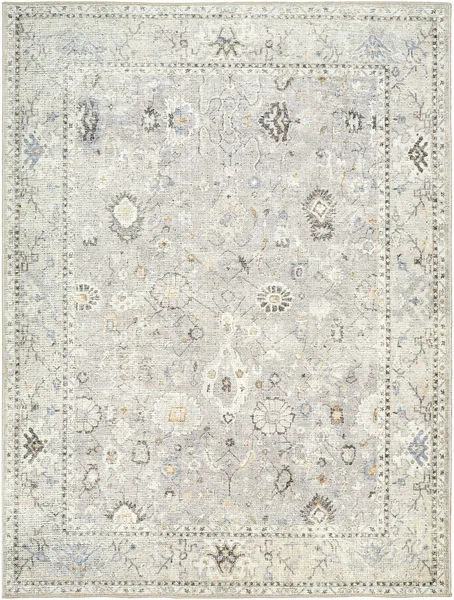 Davina Denim/Gray Machine Woven Rug with an intricate traditional floral pattern in muted blue, gray, and beige tones
