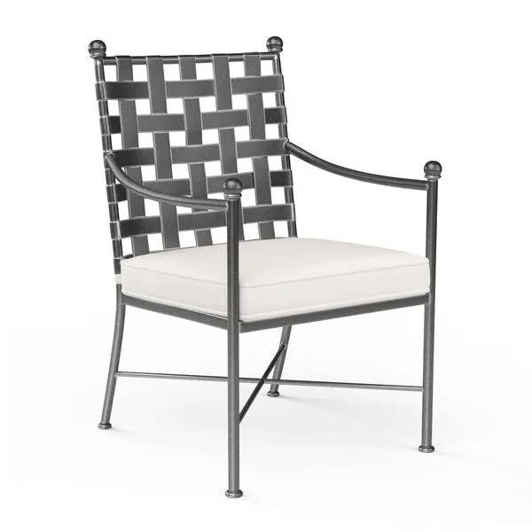 Provence Dining Chair with woven basket-weave wrought iron back, bowed arms, and cushioned cream seat in pewter finish