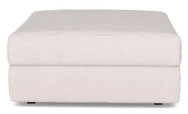 Neutral-toned fabric ottoman with clean lines and a plush, cushioned top from the Lucy Modular Sectional collection.