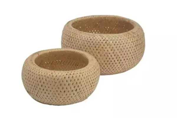 Set of two round natural bamboo baskets with woven holes and warm earthy tones