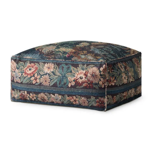 Square tapestry-inspired pouf with blue forest pattern and floral border, designed as a soft accent or footstool