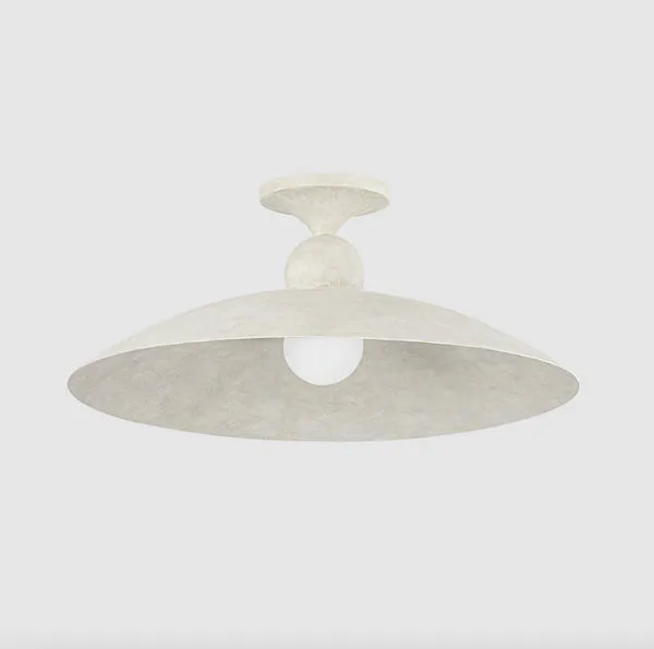 Side angle of lit flush mount ceiling light emphasizing soft limewash texture and subtle curvature