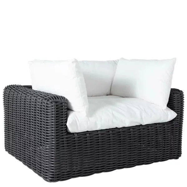 Montecito woven black rattan outdoor lounge chair with large white cushions and wide armrests