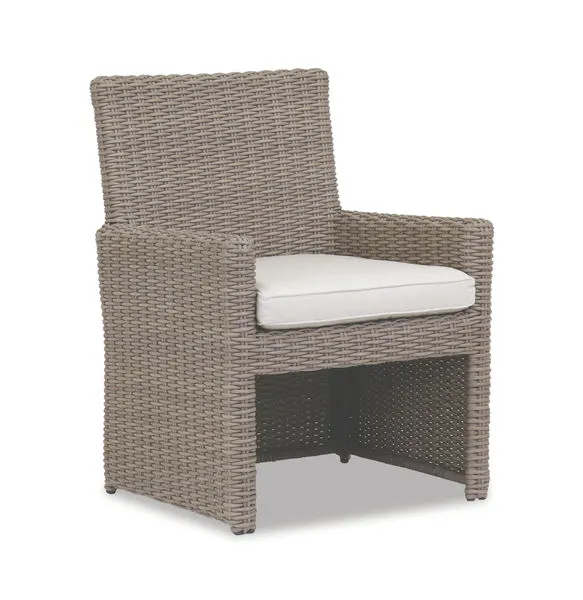 Coronado Dining Chair in driftwood resin wicker with plush off-white cushion and transitional armrest design