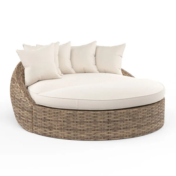 Havana Round Daybed with all-weather wicker in rich Aged Tobacco and plush cream cushions and pillows
