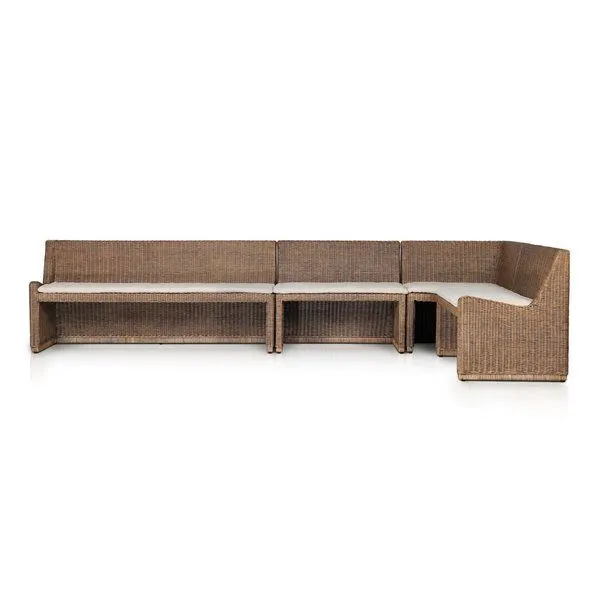 Coastal style Senna Dining Banquette in rattan with soft lines and cream fabric cushion in an angled sectional shape