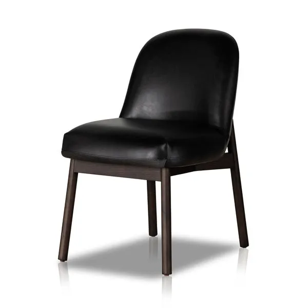 Black leather armless dining chair with curved backrest and dark wood legs