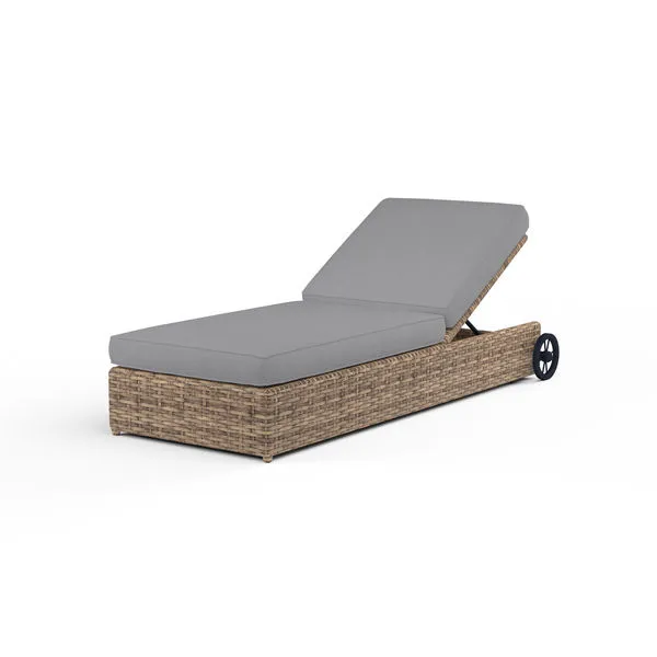 Outdoor adjustable chaise lounge in weathered tobacco wicker with gray cushioned seat and backrest, with backrest reclined