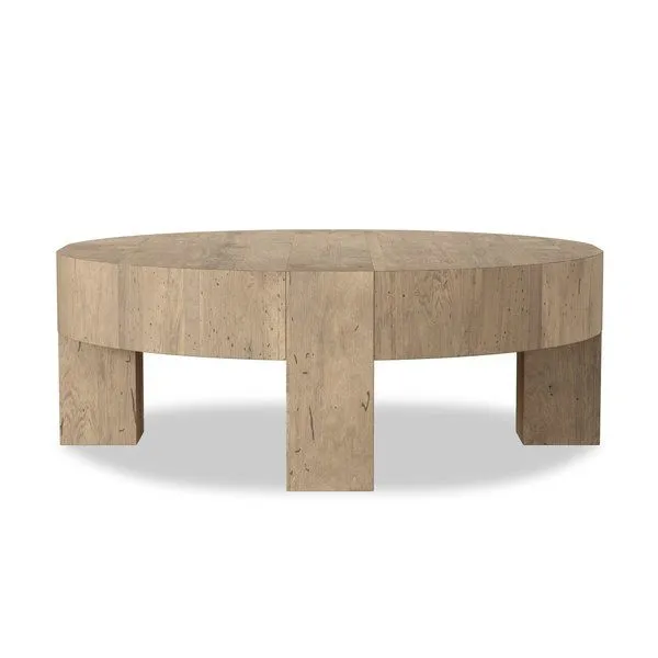 Large round coffee table made from thick-cut oak veneer with chunky squared legs and rustic wormwood oak finish