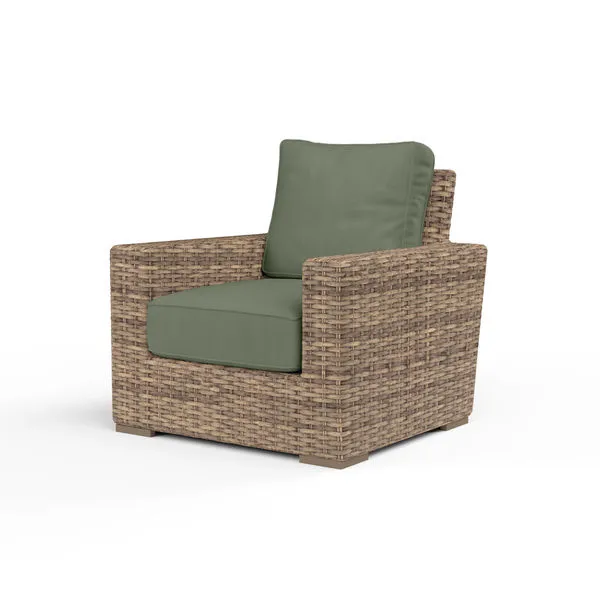 Outdoor Havana Club Chair in aged tobacco wicker with green cushions and ample square frame