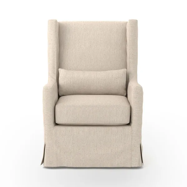 Front view of swivel chair showing full wingback and pleated skirt detailing