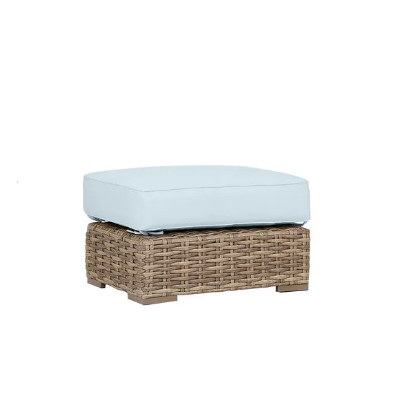 Havana Ottoman in rich aged tobacco wicker with a light blue outdoor cushion on top