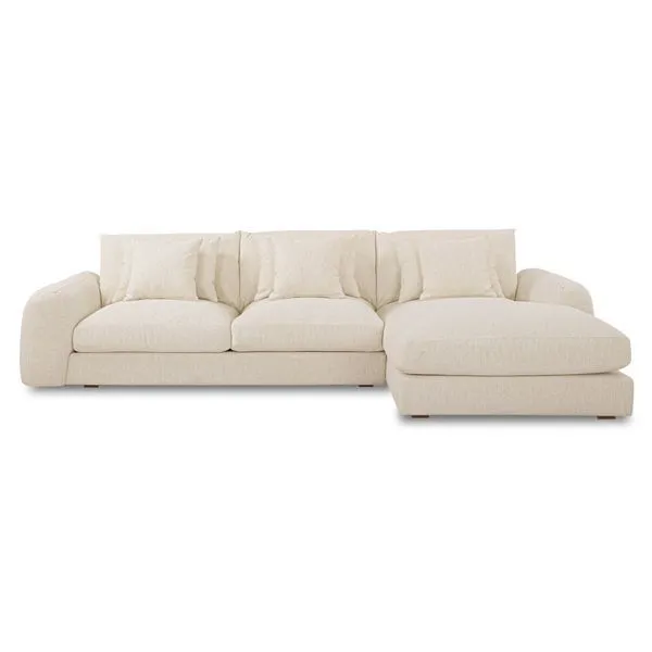 Berga Sectional in soft beige fabric with plush seat cushions and toss pillows, featuring a chaise on the right side