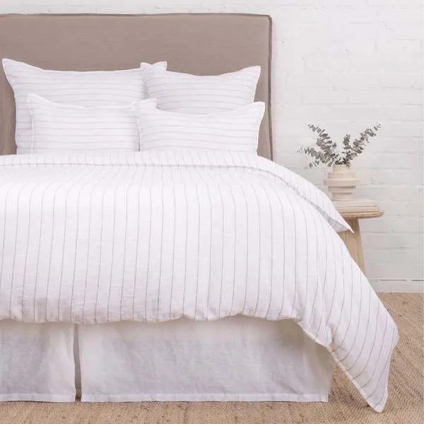 Blake White/Natural duvet with subtle interwoven stripe texture, displayed on bed with matching shams and white bed skirt