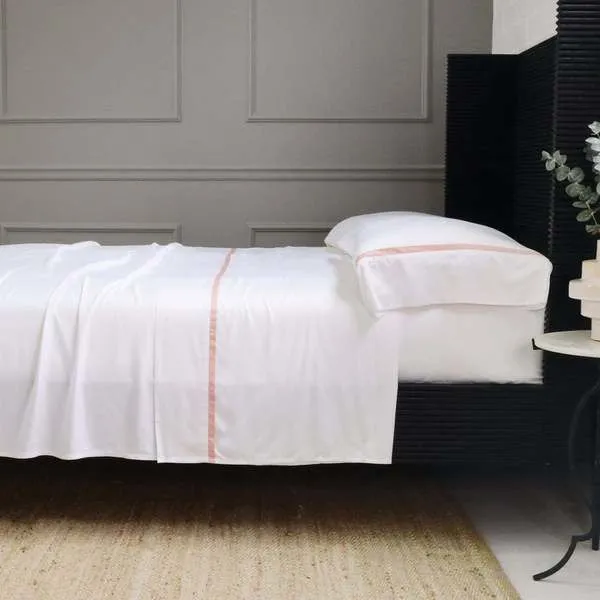 Langston Bamboo Sateen Sheet Set in soft pink on queen bed with pillowcases, smooth and breathable fabric