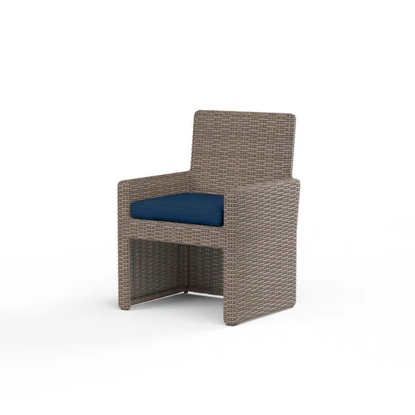 Coronado Dining Chair with resin wicker finish in Driftwood and navy blue plush cushion