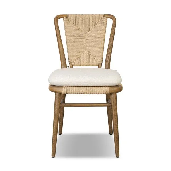 Greylin Dining Chair with woven backrest, curved wood frame, and cream cushion tied with fabric cords