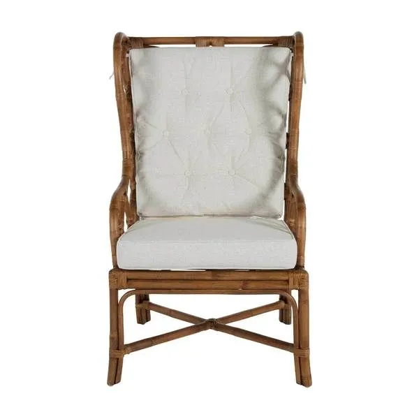 Front view showing tufted linen back cushion and geometric rattan framing on antique wooden legs
