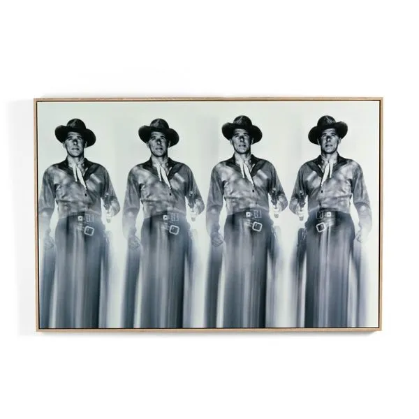 Black and white photograph of Ronald Reagan in cowboy attire repeated four times with a blurred lower half, framed in wood