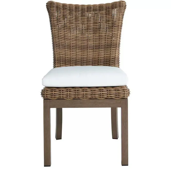 Montecito Dining Side Chair with woven rattan backrest and seat frame, white cushion, and wood-look legs
