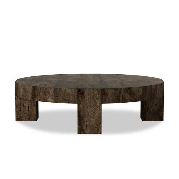 Large round coffee table in dark rustic oak veneer with thick top, chunky squared legs, and dovetail joinery