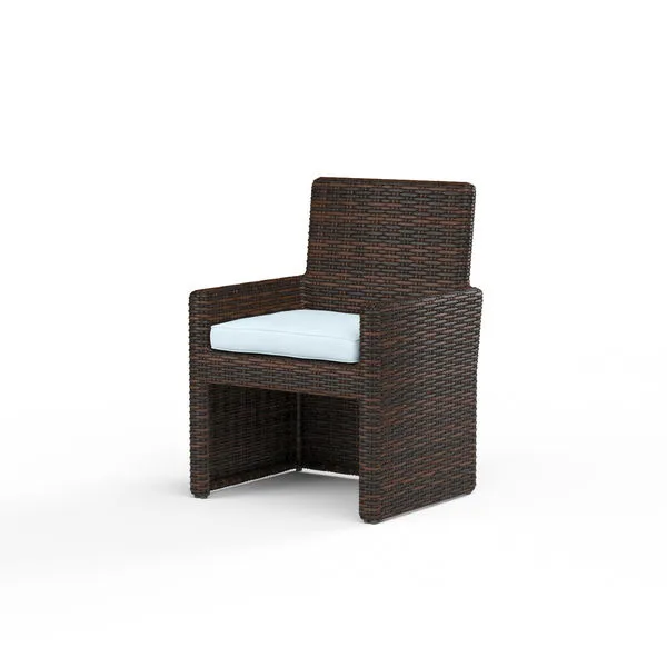 Montecito Armless Outdoor Dining Chair in rich Cognac multi-colored resin wicker with white seat cushion