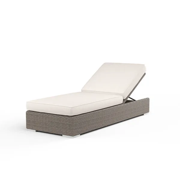Outdoor adjustable chaise with driftwood resin wicker base and plush off-white cushions, reclined backrest