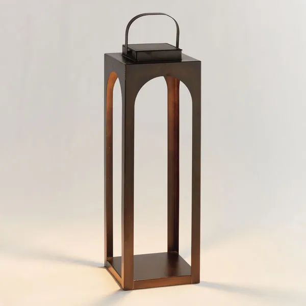 Tall rectangular outdoor lantern with bronze finish, arched openings, solar panel top, and handle