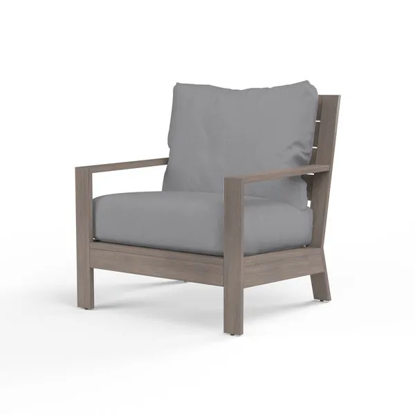 Outdoor Laguna Club Chair with hand-brushed driftwood aluminum frame and gray cushioned seat and back