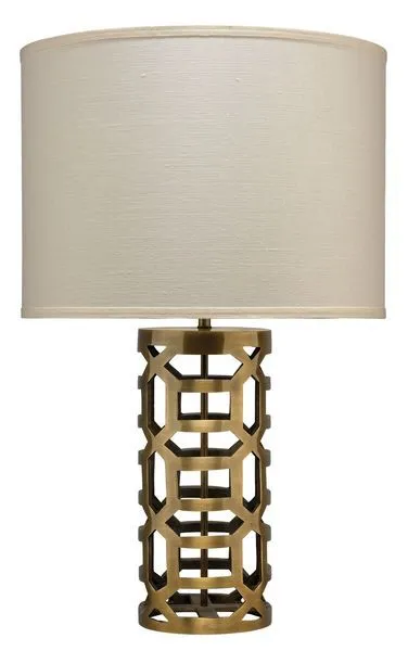 Labyrinth Table Lamp with rich antique brass metalwork in a hollow maze pattern and a beige fabric drum shade