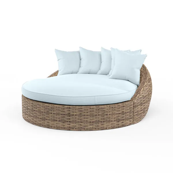 Havana Round Daybed with all-weather wicker frame in aged tobacco and light blue plush cushions and pillows